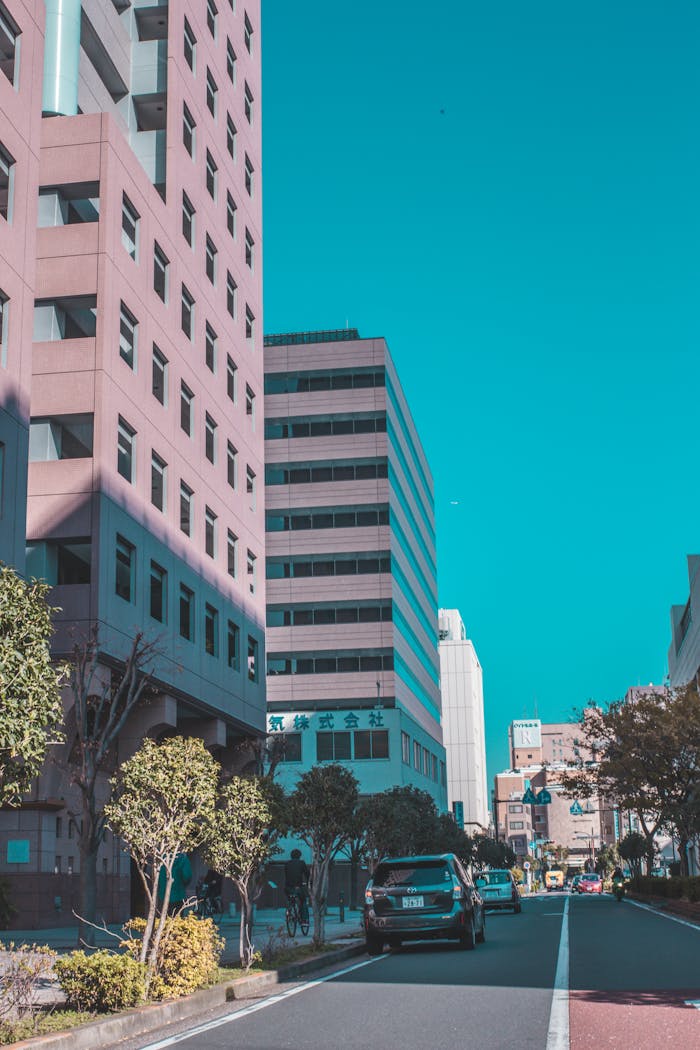 Urban scene capturing modern buildings and street life on a bright day.